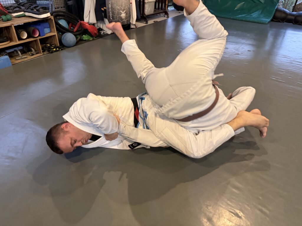 Two people practicing Brazilian Jiu-Jitsu.